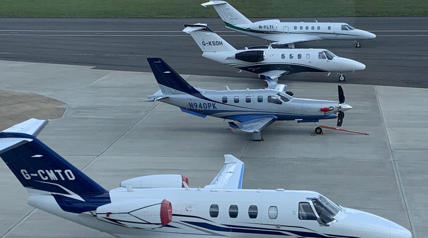 Private jets lined up on the airport apron