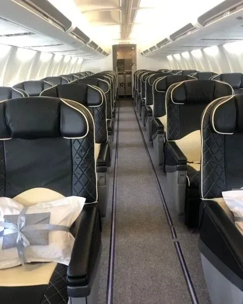 Charter-a ltd interior view of a luxurious private jet cabin with plush seating